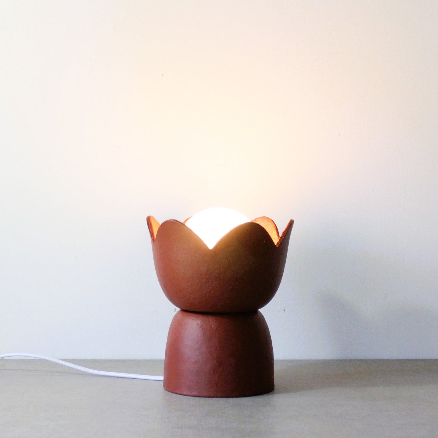 Tulip paper clay table lamp in red earth colour